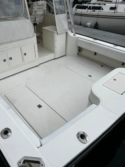 Slide: The Image of 2005 Carolina Classic 28 Express boat with spacious deck and storage compartments. - 6