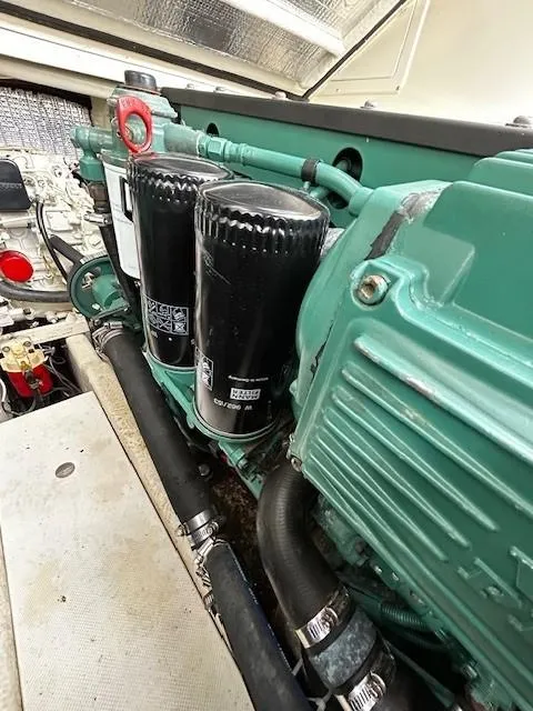 Slide: The Image of Engine compartment of a 2005 Carolina Classic 28 Express boat, showcasing filters and components. - 9