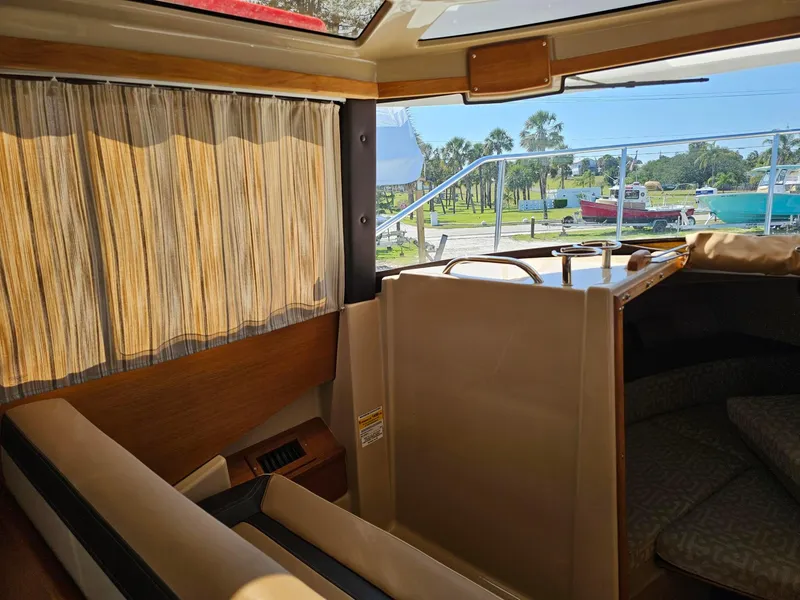 Slide: The Image of Interior of 2019 Ranger Tugs 23R boat with seating and outdoor view. - 16