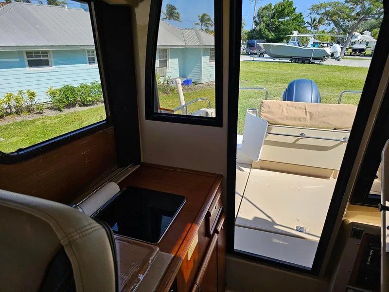 Slide: The Image of Interior view of 2019 Ranger Tugs 23R boat with outdoor seating and window. - 18