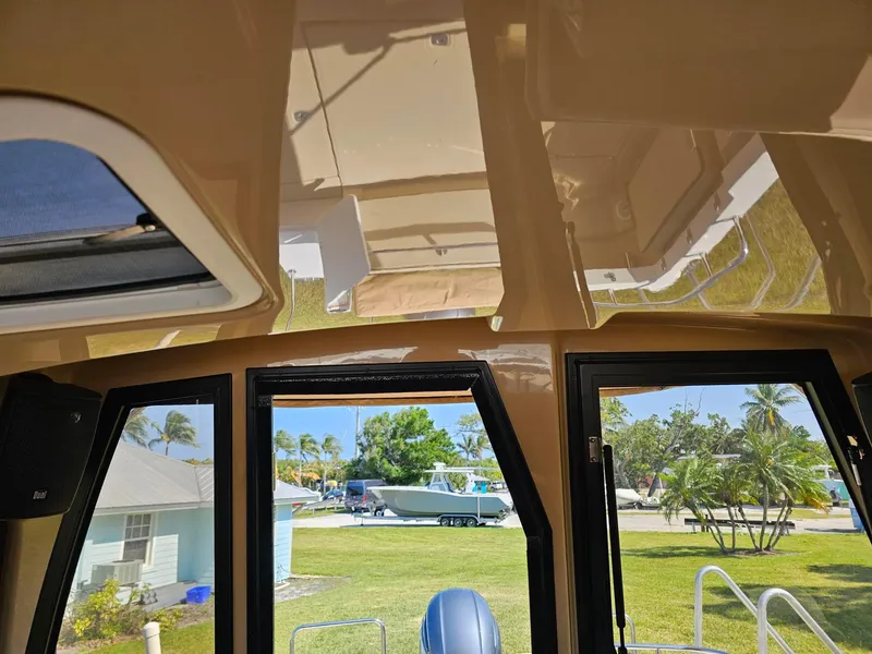 Slide: The Image of Interior view of 2019 Ranger Tugs 23R boat with windows and outdoor scenery. - 19