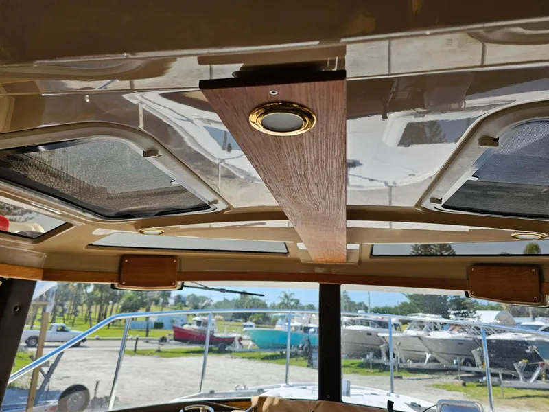 Slide: The Image of Interior view of 2019 Ranger Tugs 23R boat ceiling with skylights and wood paneling. - 20