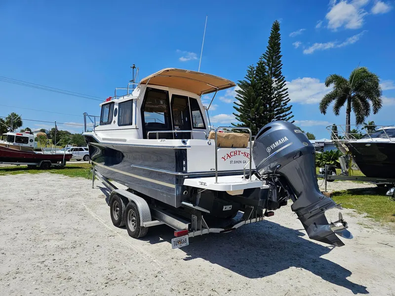 Slide: The Image of 2019 Ranger Tugs 23R boat on trailer with Yamaha outboard motor, parked outdoors. - 5