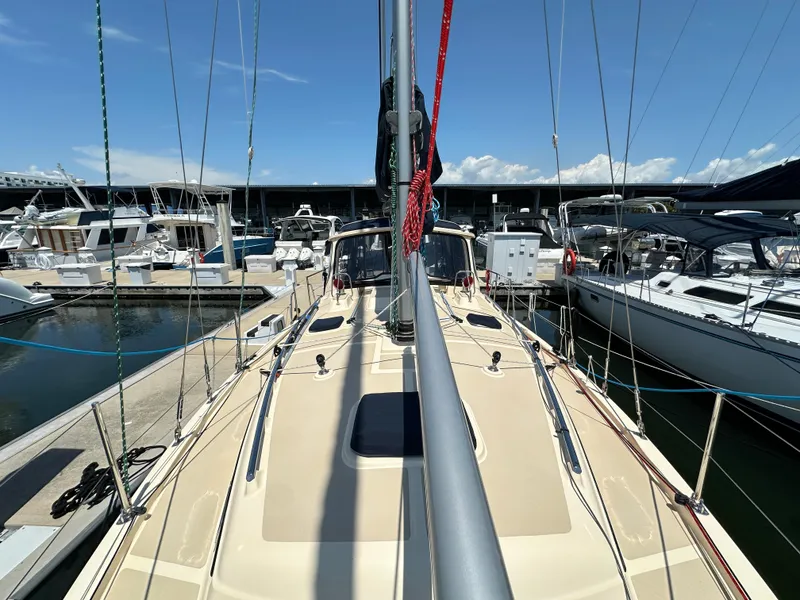 Slide: The Image of 2021 Island Packet 349 sailboat docked at marina under clear blue sky. - 10