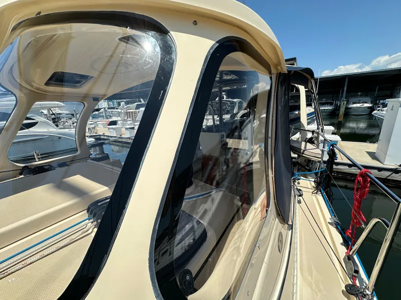 Slide: The Image of 2021 Island Packet 349 sailboat docked, showcasing cockpit and marina view. - 13