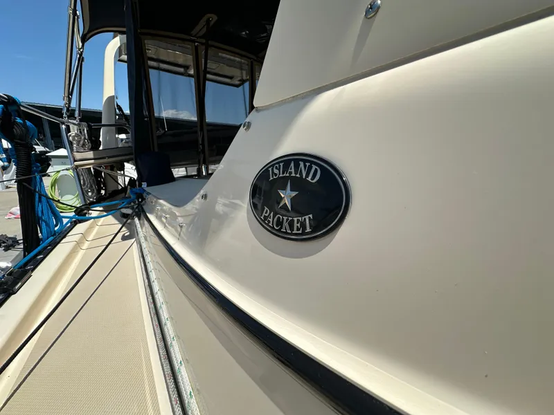 Slide: The Image of Island Packet 349 sailboat, 2021 model, docked with visible logo and deck details. - 18