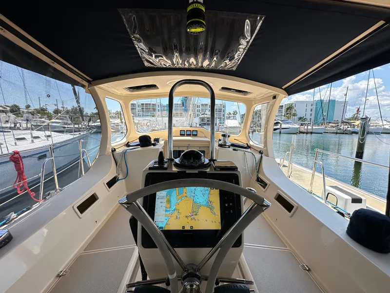 Slide: The Image of Cockpit view of 2021 Island Packet 349 sailboat with navigation display, docked at marina. - 20