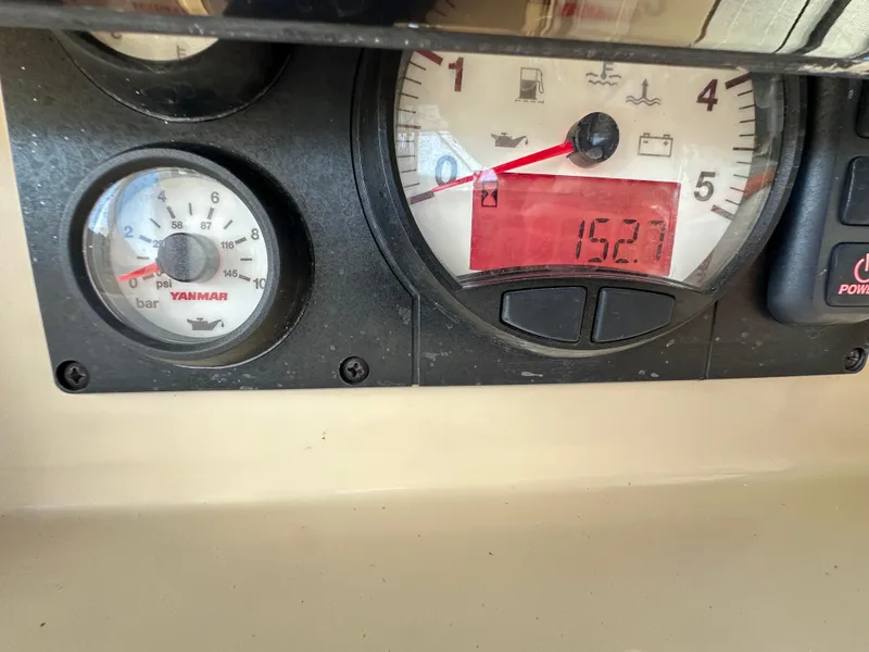 Slide: The Image of Close-up of 2021 Island Packet 349 engine gauges displaying 152.7 hours and Yanmar pressure. - 21