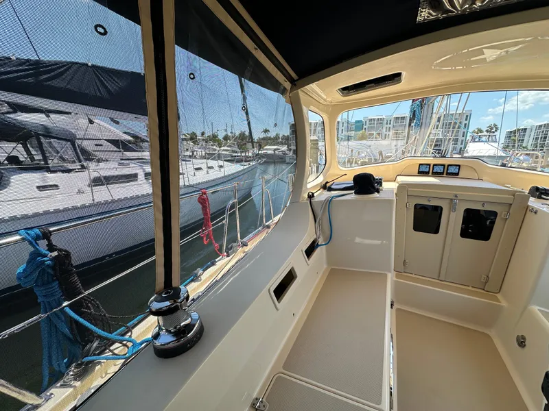 Slide: The Image of 2021 Island Packet 349 sailboat cockpit with marina view, featuring modern navigation equipment. - 22