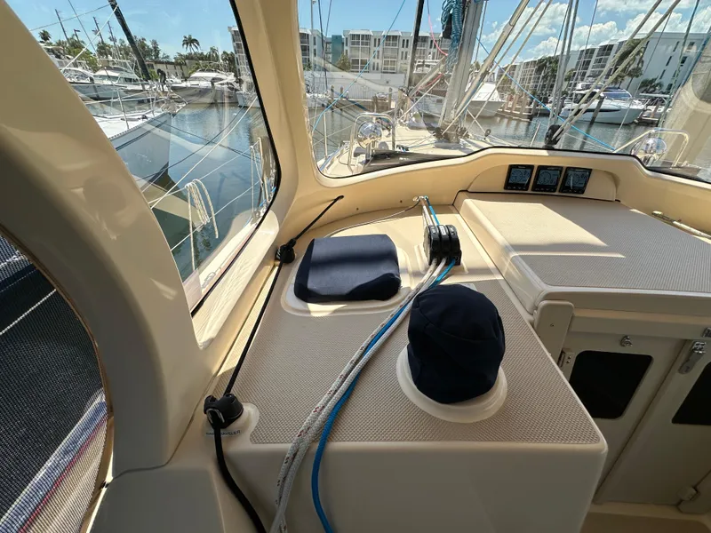 Slide: The Image of 2021 Island Packet 349 sailboat cockpit with marina view, showcasing navigation instruments and rigging. - 24
