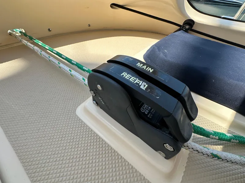 Slide: The Image of Close-up of a 2021 Island Packet 349 sailboat's rope clutches labeled "Main" and "Reef." - 27
