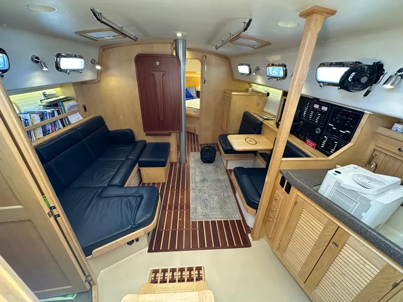 Slide: The Image of Interior of 2021 Island Packet 349 sailboat with modern furnishings and wood accents. - 29