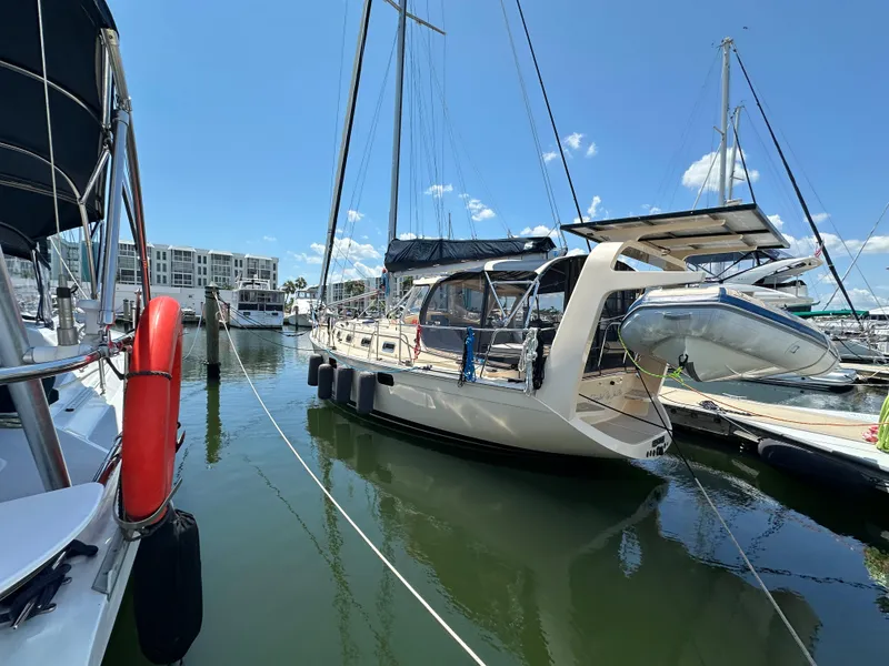Slide: The Image of 2021 Island Packet 349 sailboat docked at marina under clear blue sky. - 3