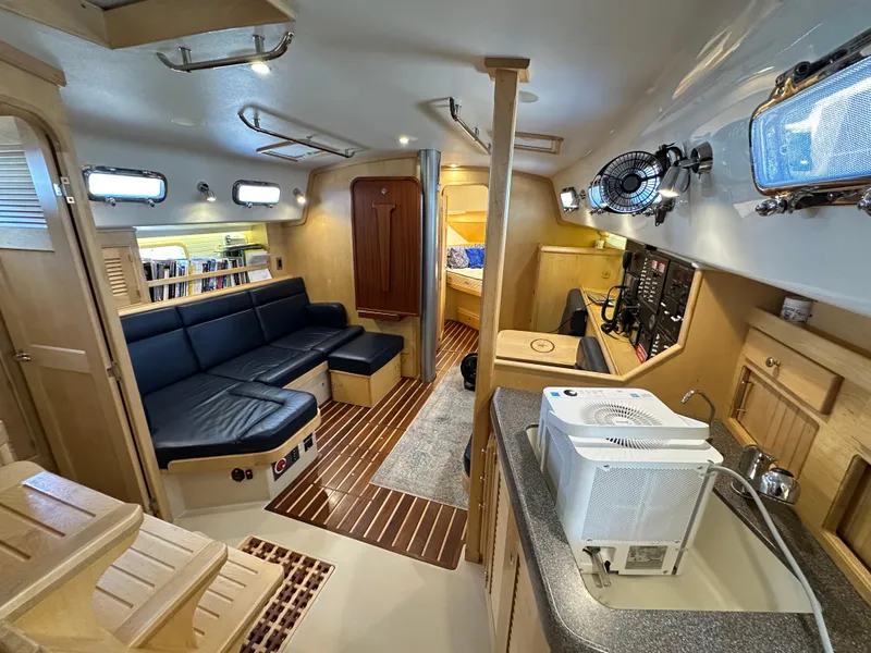 Slide: The Image of Interior of 2021 Island Packet 349 sailboat with modern amenities and cozy seating area. - 34