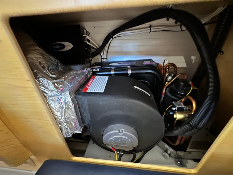 Slide: The Image of Engine compartment of a 2021 Island Packet 349 sailboat, showcasing mechanical components. - 36
