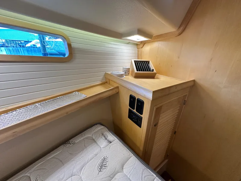 Slide: The Image of Cozy cabin interior of 2021 Island Packet 349 sailboat with wooden accents and window view. - 41