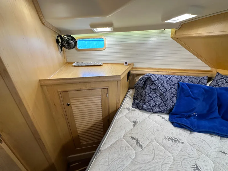 Slide: The Image of Cozy cabin interior of 2021 Island Packet 349 sailboat with bed and storage. - 42