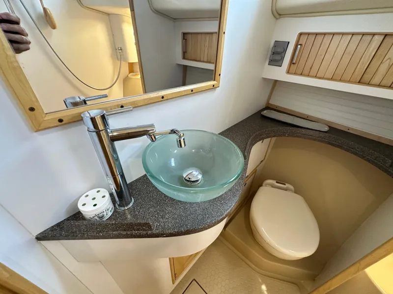 Slide: The Image of Modern bathroom in 2021 Island Packet 349 yacht with glass sink and wooden accents. - 45