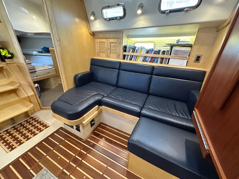 Slide: The Image of Luxurious interior of 2021 Island Packet 349 yacht with blue leather seating and wooden flooring. - 47