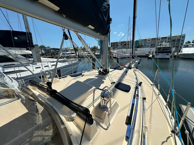 Slide: The Image of 2021 Island Packet 349 sailboat docked at marina, showcasing deck and rigging. - 6