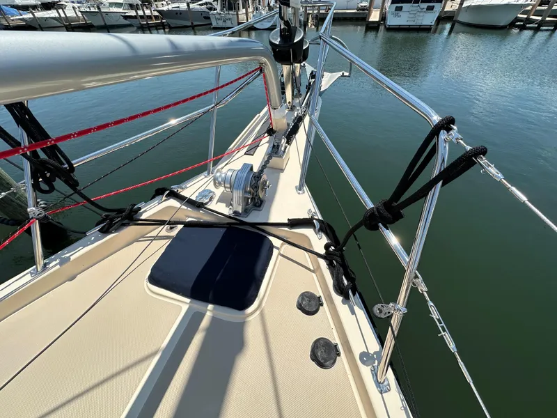 Slide: The Image of 2021 Island Packet 349 sailboat deck with rigging and winch, docked at marina. - 8