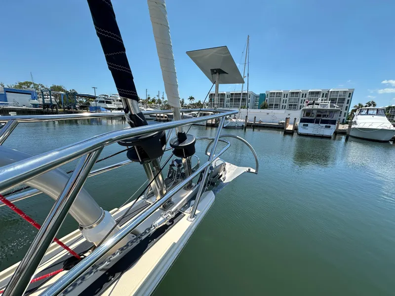 Slide: The Image of Bow of 2021 Island Packet 349 sailboat docked in marina, clear blue sky. - 9