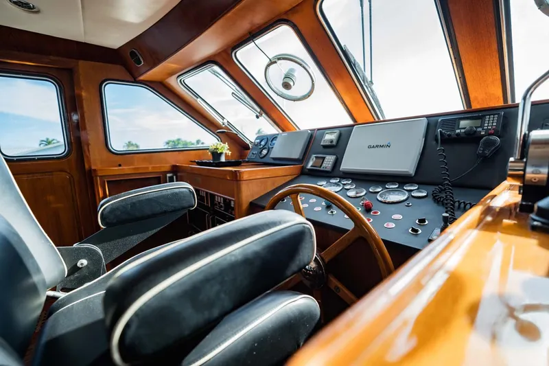 Slide: The Image of Interior of 1985 Lowland 68 Neth Ships, featuring a classic wooden helm and modern controls. - 10