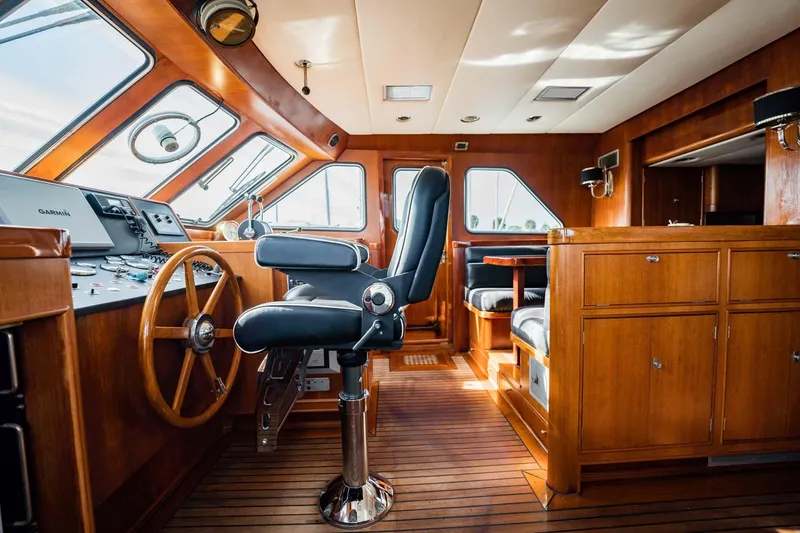 Slide: The Image of Interior of 1985 Lowland 68 Neth Ships, featuring wooden helm and seating area. - 11