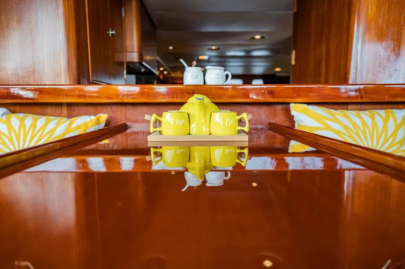Slide: The Image of Luxurious yacht interior with yellow teapot, wooden table, and decorative cushions, Lowland 68 Neth Ships. - 14