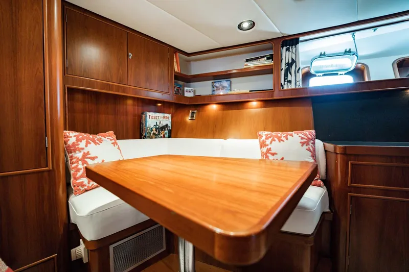 Slide: The Image of Cozy 1985 Lowland 68 Neth Ships yacht interior with wooden table and cushioned seating. - 17