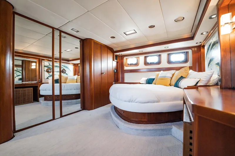 Slide: The Image of Luxurious yacht bedroom with wood paneling, round bed, and mirrored closet, Lowland 68 Neth Ships 1985. - 18