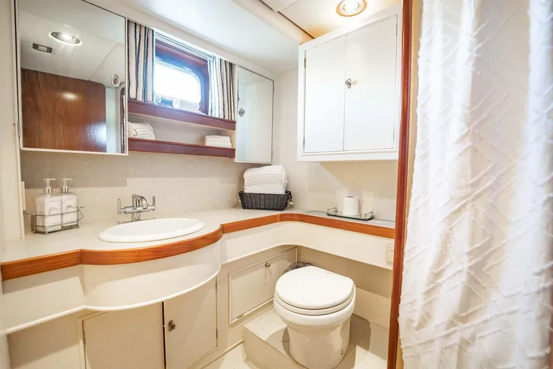 Slide: The Image of Luxurious yacht bathroom with modern fixtures, white cabinetry, and a porthole window. Lowland 68 Neth Ships. - 26