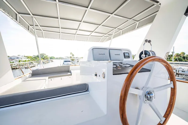 Slide: The Image of 1985 Lowland 68 Neth Ships yacht helm with wooden steering wheel and cushioned seating. - 30