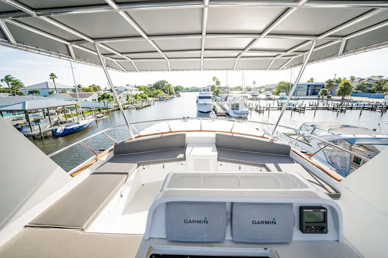 Slide: The Image of Flybridge view of 1985 Lowland 68 Neth Ships yacht, featuring Garmin navigation, docked in marina. - 31