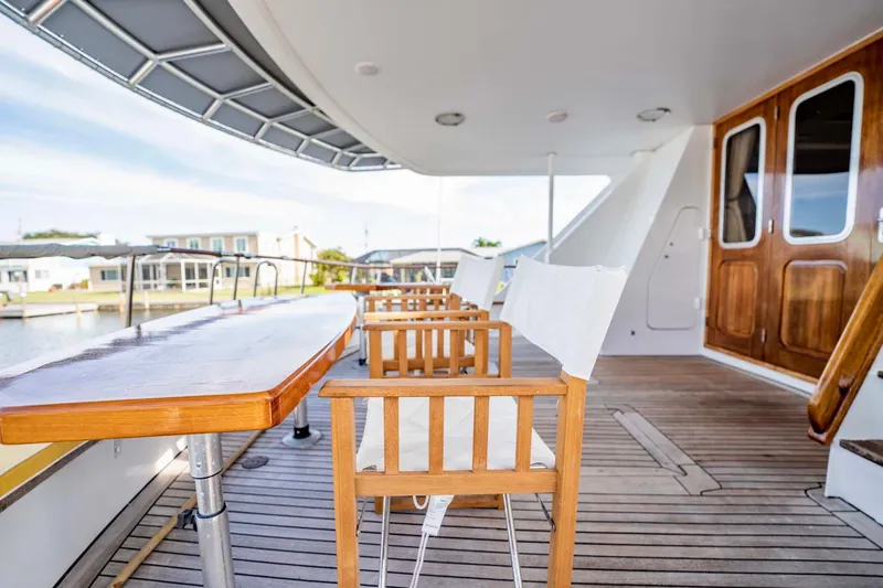 Slide: The Image of Spacious deck of 1985 Lowland 68 Neth Ships with wooden furniture and scenic view. - 32