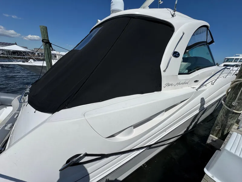 Slide: The Image of 2003 Sea Ray 500 Sundancer yacht docked at marina, featuring sleek white design. - 11
