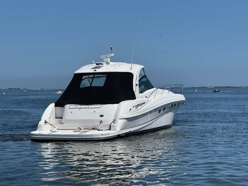 Slide: The Image of 2003 Sea Ray 500 Sundancer yacht cruising on calm blue waters. - 3