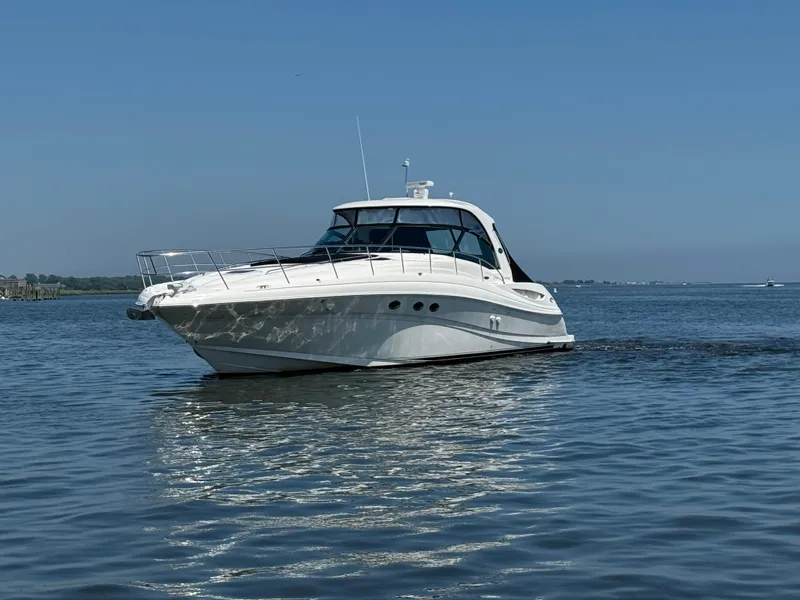 Slide: The Image of 2003 Sea Ray 500 Sundancer yacht cruising on calm waters under clear blue skies. - 5
