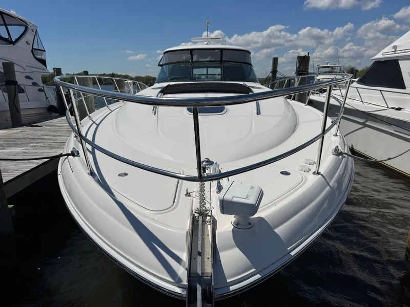 Slide: The Image of 2003 Sea Ray 500 Sundancer yacht docked under a clear blue sky. - 7