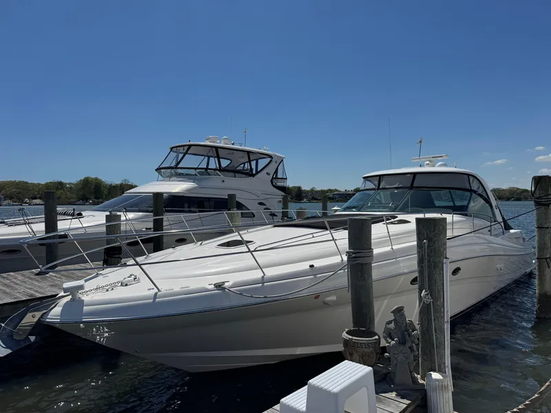 Slide: The Image of 2003 Sea Ray 500 Sundancer yacht docked at marina under clear blue sky. - 8