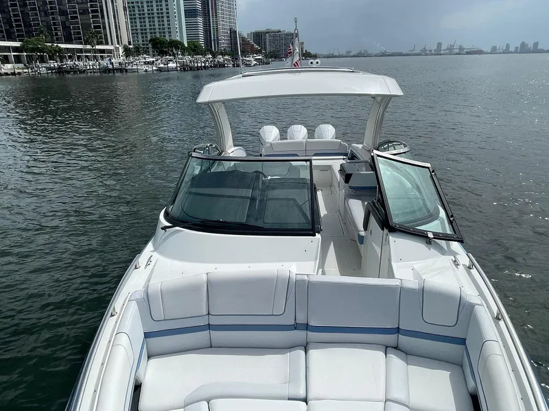 Slide: The Image of 2023 Formula 330 Crossover Bowrider OB on calm water near city skyline. - 10