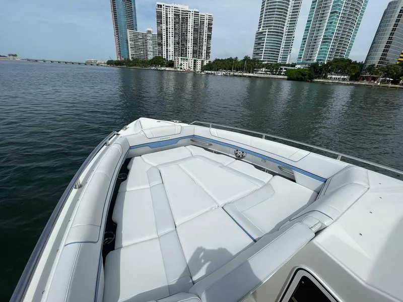 Slide: The Image of 2023 Formula 330 Crossover Bowrider OB on water with city skyline background. - 11