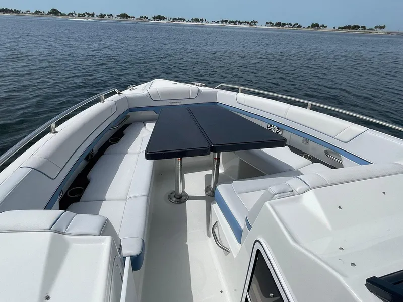 Slide: The Image of 2023 Formula 330 Crossover Bowrider OB on water, featuring spacious seating and table. - 13
