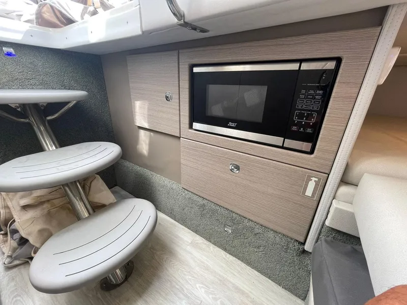 Slide: The Image of 2023 Formula 330 Crossover Bowrider OB interior with microwave and seating area. - 14