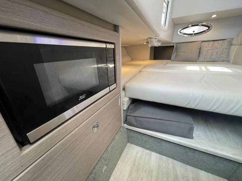 Slide: The Image of 2023 Formula 330 Crossover Bowrider OB cabin with bed and microwave. - 15