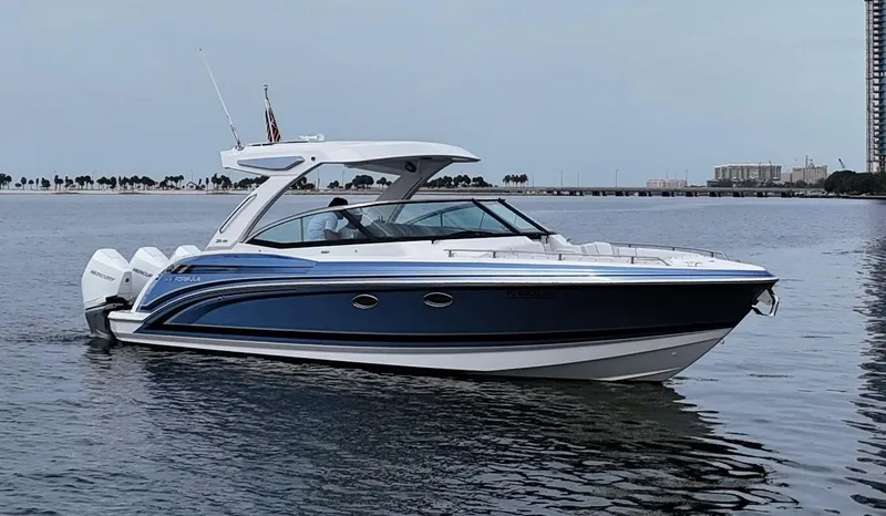 Slide: The Image of 2023 Formula 330 Crossover Bowrider OB on calm water, side view. - 2