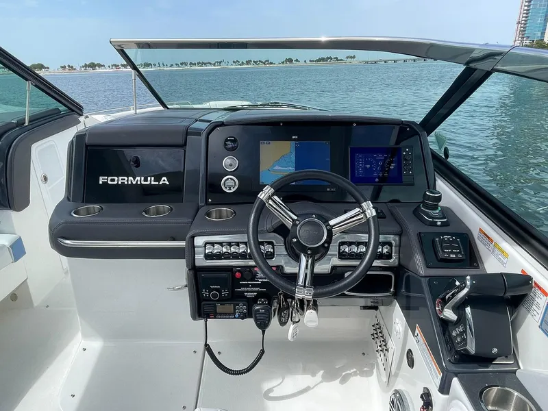 Slide: The Image of 2023 Formula 330 Crossover Bowrider OB helm with modern controls and navigation screens. - 20