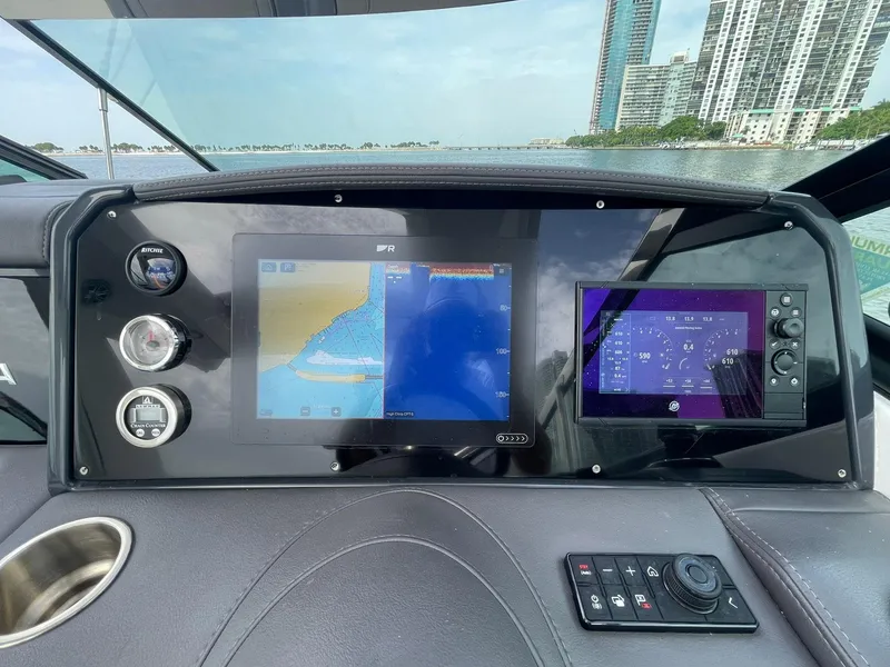 Slide: The Image of 2023 Formula 330 Crossover Bowrider OB dashboard with navigation screens and controls. - 21