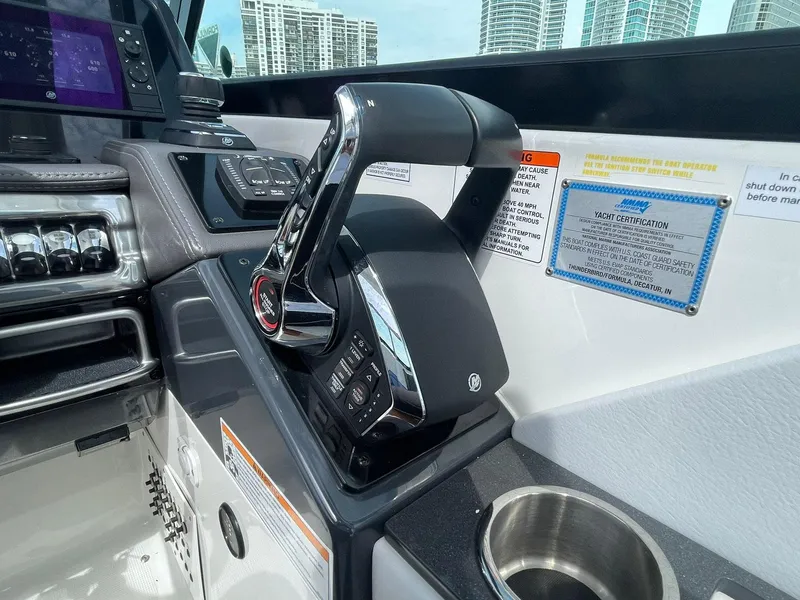 Slide: The Image of 2023 Formula 330 Crossover Bowrider OB cockpit controls with modern dashboard and throttle. - 23