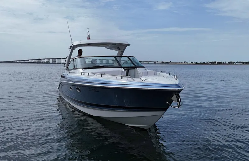 Slide: The Image of 2023 Formula 330 Crossover Bowrider OB on calm water, showcasing sleek design. - 3